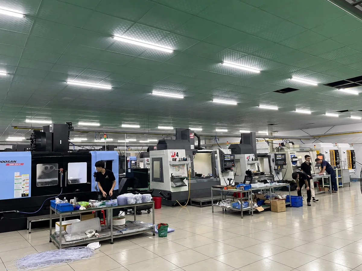 CNC machining hall with rows of milling centers and operators at Far East High Tech, Vietnam