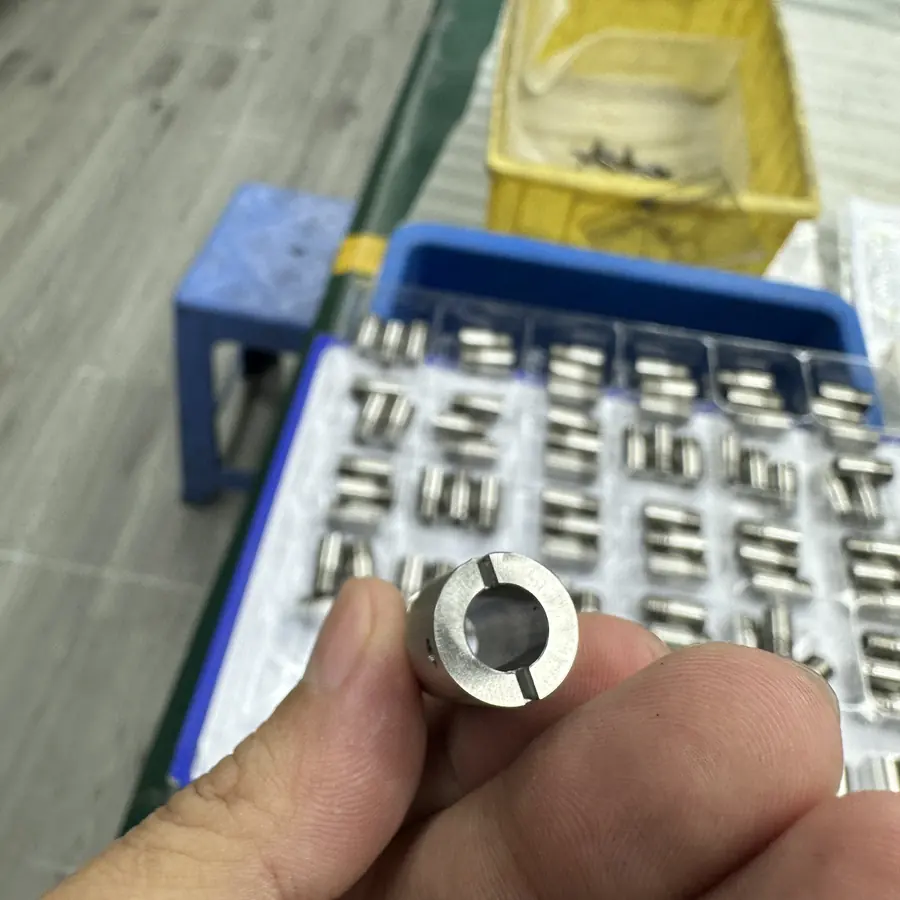 CNC turned sleeve showing concentric bore and two milled slots across the end face