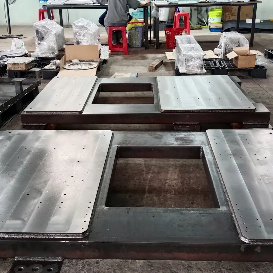 Large welded machine bases with machined top plates and a centre opening on the shop floor
