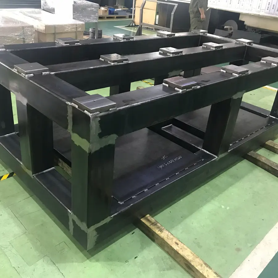 Welded machine frame from box section with machined mounting pads on top